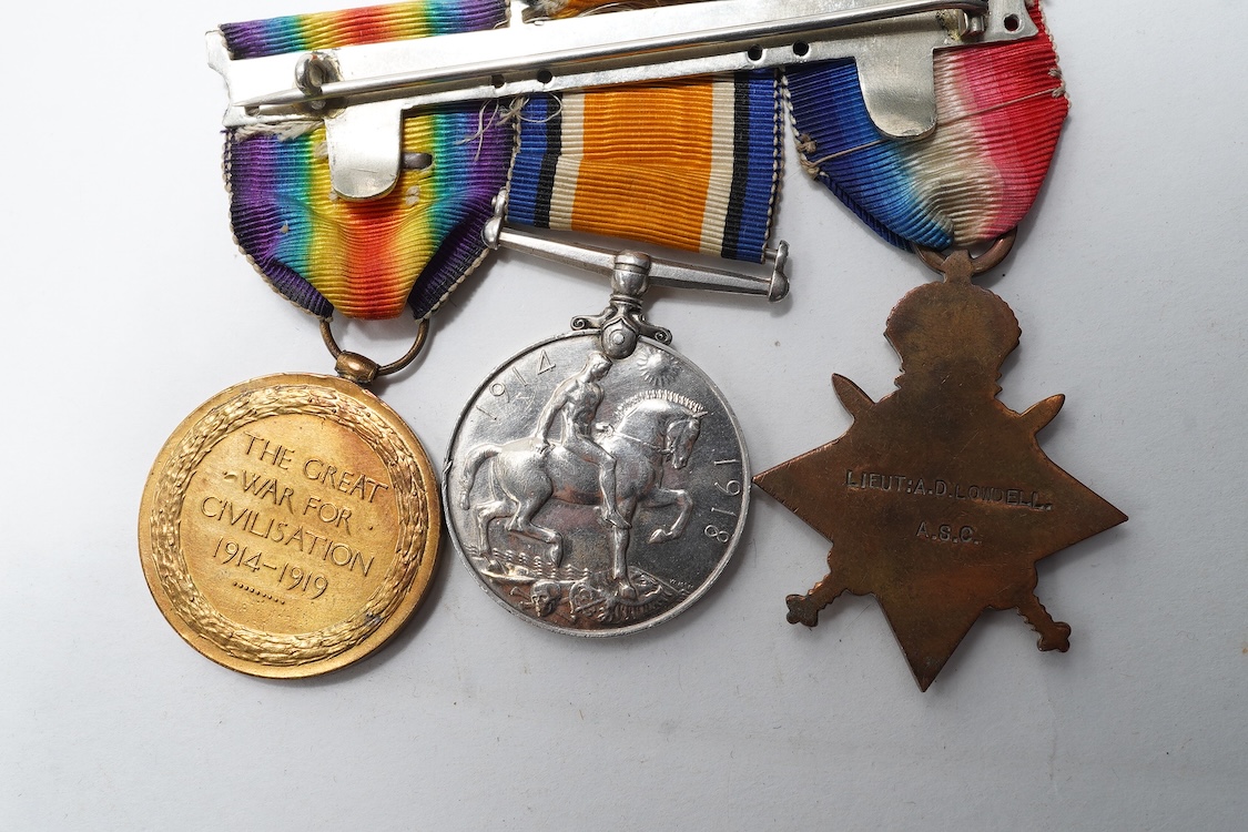 A First World War Mons Star trio awarded to Capt. A.D. Lowdell, with a clasp for 5th Aug-22nd Nov 1914, and oakleaf - mention in dispatches, together with the miniature set, plus a WWII Defence medal in its original card